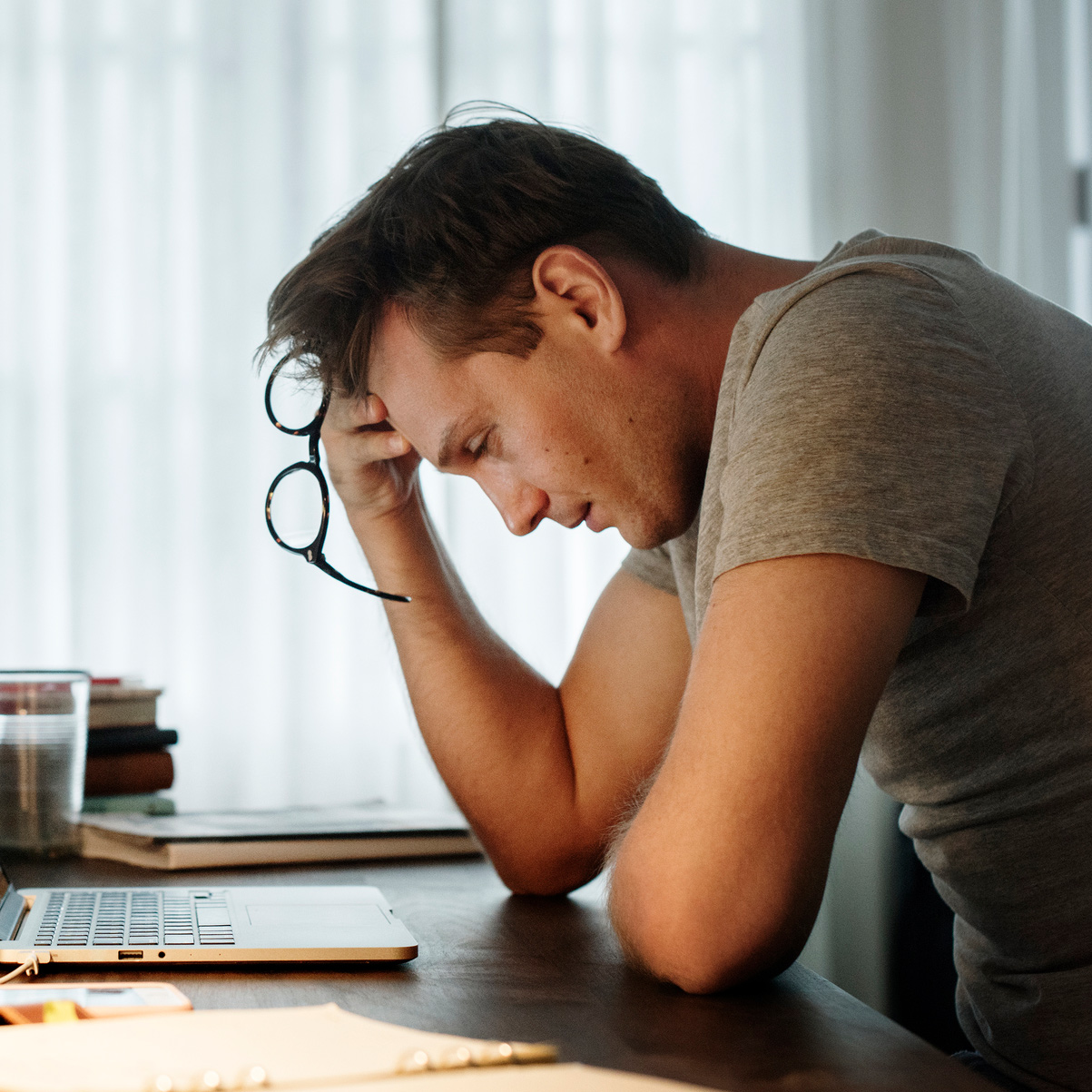 Man stressed while working on laptop